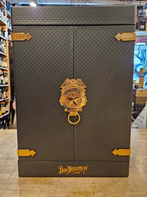 Decorative box with gold emblem and text on a wooden surface