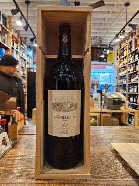 Wine bottle in a wooden box with a blurred store interior in the background