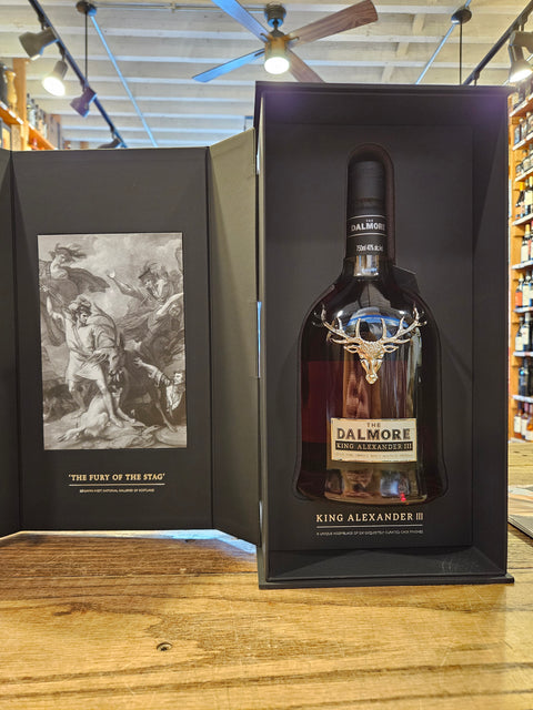 King Alexander whiskey bottle in a black box on a wooden surface