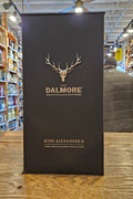 Dalmore King Alexander III whisky box on a wooden surface with a blurred indoor background
