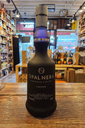 Opalinaera bottle on a wooden surface with a store interior in the background