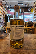 Bottle of Absinthe Verte on a wooden surface with a blurred bar background