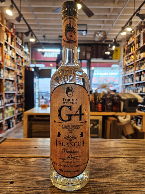 Bottle of G4 Blanco tequila on a wooden surface with a blurred bar background