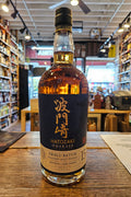 Bottle of Hatozaki Oakmash whiskey on a wooden surface with a store interior in the background