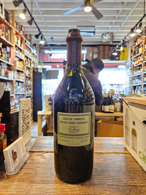 Bottle of liquor on a store shelf with a person in the background
