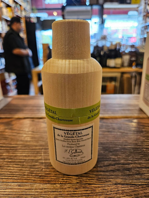 Bottle of Vegetal on a wooden surface with a blurred background