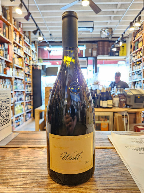 Wine bottle with a label on a wooden surface in a store setting