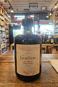 Bottle of Gentiane on a wooden surface with a store interior in the background