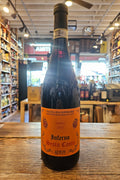 Wine bottle with orange label on a wooden surface in a store setting
