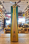 Bottle of Tequila Don Julio 1942 on a wooden surface with a store interior in the background