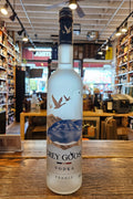 Bottle of Grey Goose vodka on a bar counter with a blurred bar background
