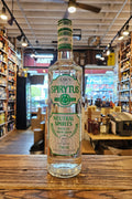 Baks Spirytus clear bottle with green outlined label on a wooden counter