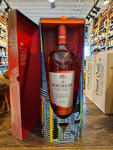 Macallan A Night on Earth - The Journey 750mL  a open colorful box with a clear tall glass bottle inside with a white and orange label and orange top