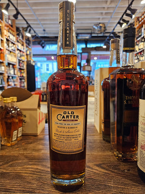 Old Carter Straight Bourbon Whiskey Batch #15 Small Batch  750mL the backside of a tall clear glass bottle with a beige label and wooden top