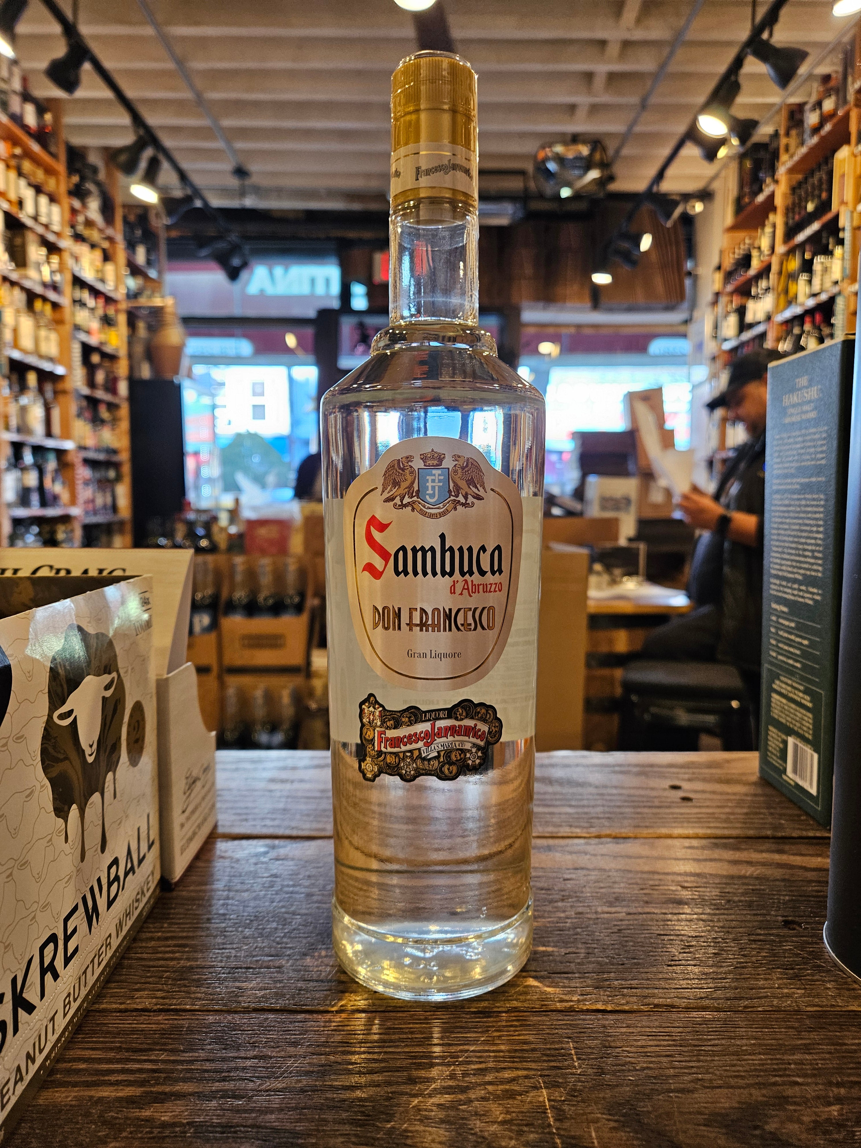 Sambuca d'Abruzzo Don Francesco 1L a tall clear glass bottle with a white label and golden top