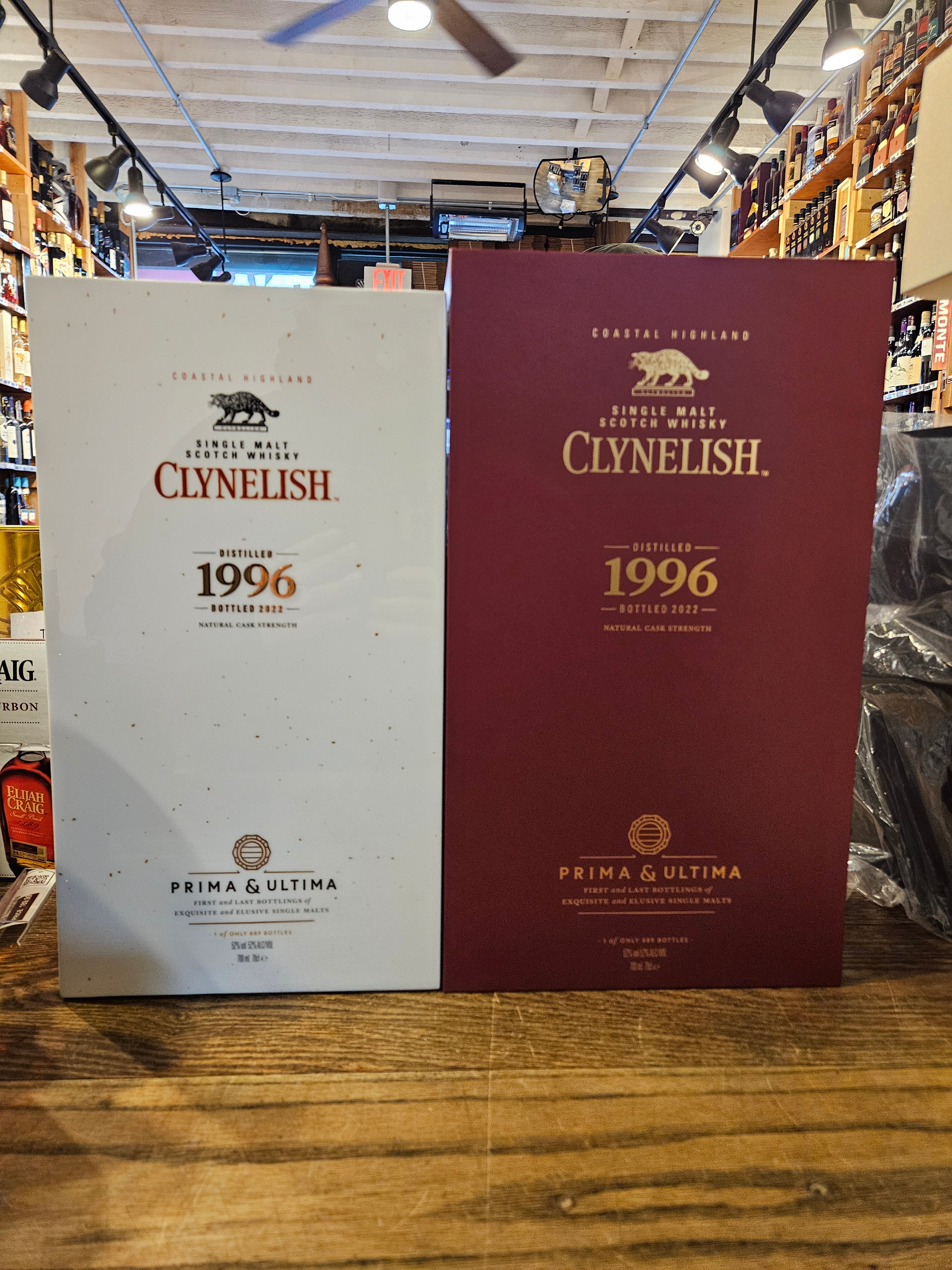 Clynelish 1996 Single Malt Scotch Whisky Prima and Ultima Fourth Release two boxes side by side with the same gold lettering. the box on the left shorter and white, the box on the right is larger and red