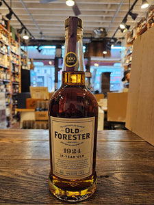Old Forester 1924 10 Year Old 750mL a tall clear high rounded shouldered glass bottle with a white label and wooden topper
