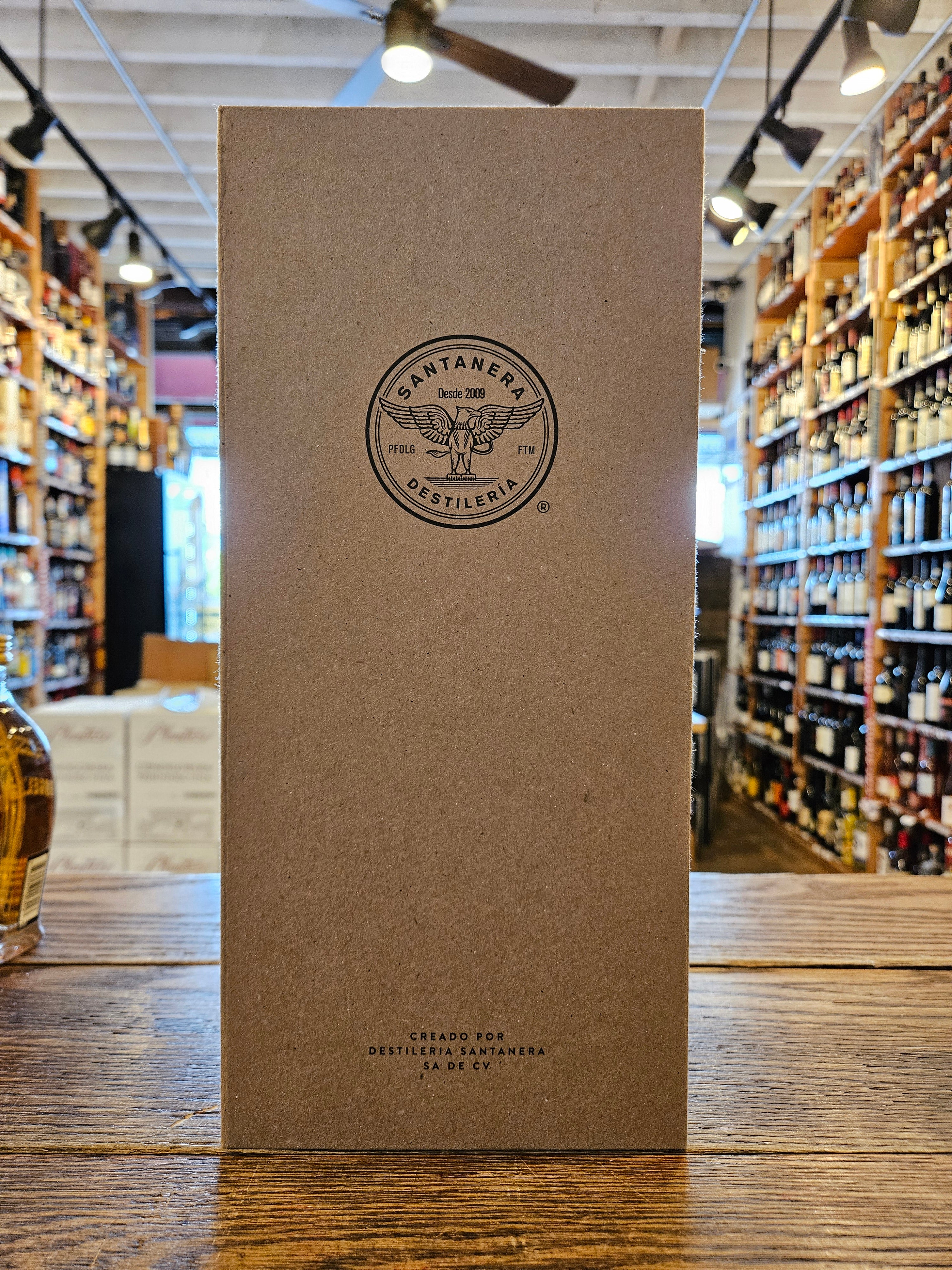 Santanera Organic Tequila Blanco Batch-Ceniza 750mL a tall rectangular brown box with a black lettering and the image of an eagle