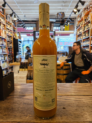 Chinola Mango Liqueur 750mL the backside of a tall slender clear glass bottle with a light green blue label and white top
