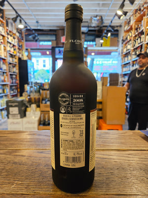 Florio Marsala Superiore Riserva Semisecco 750mL the backside of a dark frosted glass bottle with a large beige label and a black top.
