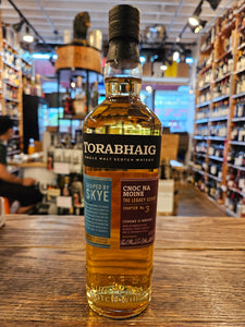 Torabhaig Single Malt Scotch Whisky Cnoc Na Moine 750mL a tall rectangular shaped clear glass bottle with a black, blue, and maroon label and black top. 