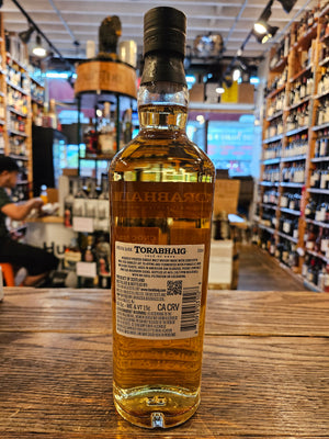 Torabhaig Single Malt Scotch Whisky Cnoc Na Moine 750mL the backside of a tall rectangular shaped clear glass bottle with a white label and black top.