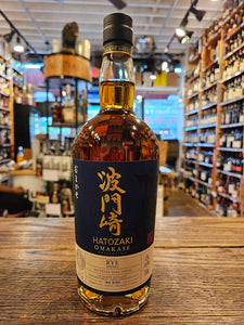 Hatozaki Omakase Rye 750mL a clear glass bottle with rounded shoulders and a blue label and a black top 