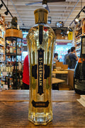 St Germain 750mL a tall clear elegantly shaped bottle with a gold top and a blue label 