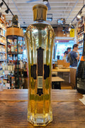 St Germain 750mL a tall clear elegantly shaped bottle with a gold top and a blue label 