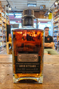 Woodinville 8 Year Straight Bourbon Whiskey 750mL a squared clear glass bottle with a black label and black top