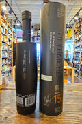 Octomore 15.1 700mL a slender frosted black glass bottle with a long neck next to a tall black cylinder. 