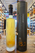 Octomore 15.3 700mL a clear frosted glass tall bottle with a black top next to a tall dark cylinder can