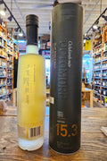Octomore 15.3 700mL a clear frosted glass tall bottle with a black top next to a tall dark cylinder can