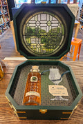 Martingale Cognac Gift Set 375mL a short clear glass bottle with indentations next to a thin stemmed glass inside an open green wooden box