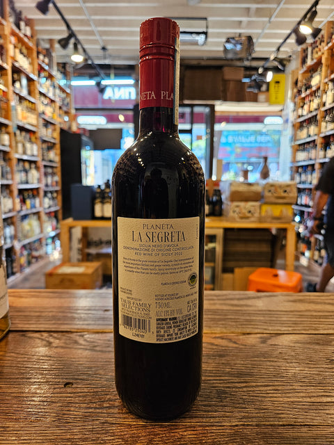 Planeta La Segreta Nero D'Avola 750mL a dark glass wine bottle with a white label and red top