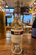 Gaja Grappa Darmagi 375mL a clear glass bottle with a white label and a silver top 