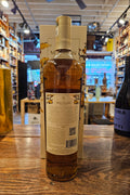 The Macallan Harmony IV Collection Vibrant Oak 750mL tall clear glass bottle with a beige label and beige top