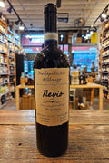 Nevio Montepulciano d'Abruzzo 750mL a dark glass wine bottle with a beige label and a black label