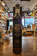 El Tesoro Paradiso Extra Anejo Tequila 750mL a tall slender brown glass bottle with a black label and wooden top