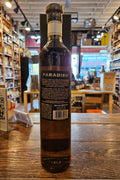 El Tesoro Paradiso Extra Anejo Tequila 750mL a tall slender brown glass bottle with a black label and wooden top