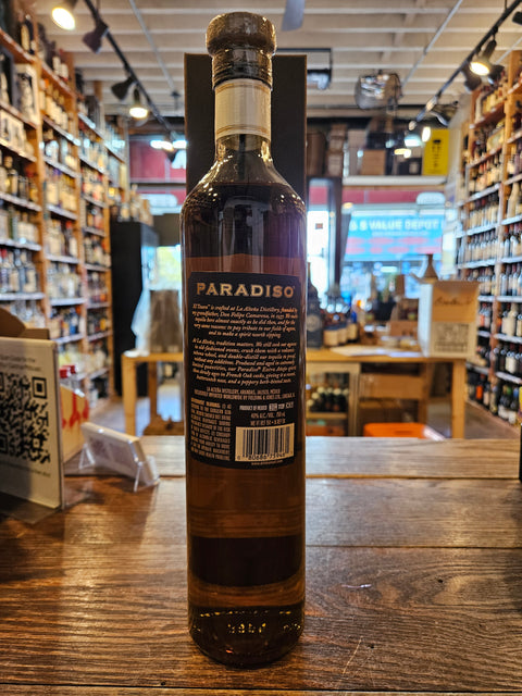 El Tesoro Paradiso Extra Anejo Tequila 750mL a tall slender brown glass bottle with a black label and wooden top