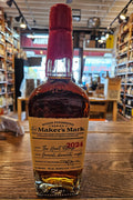 Maker’s Mark Wood Finishing Series 2024 The Heart Release 750mL a clear glass bottle with robust shoulders and beige label and a red wax top.