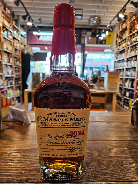 Maker’s Mark Wood Finishing Series 2024 The Heart Release 750mL a clear glass bottle with robust shoulders and beige label and a red wax top.