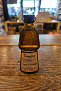 Frangelico 50mL a small human shaped brown glass bottle with a beige label and black top