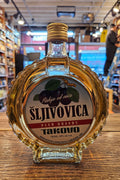 Takovo Sljivovica Plum Brandy 750mL a circular shaped clear glass bottle with a white label and golden top