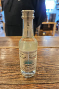 Casamigos Blanco 50mL a small clear glass bottle with a white label and silver top