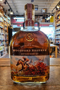 Woodford Reserve Kentucky Derby 151 Edition 1L a flat faced clear glass bottle with a colorful label of a horse and jockey and a wooden topper.