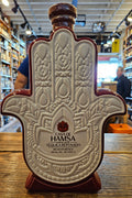 Casa De Hamsa Reposado Tequila 1L a ceramic hand shaped bottle with a white front and a wooden top