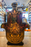 Casa De Hamsa Anejo Tequila 1L a hand shaped ceramic bottle decorated black and gold with a wooden top
