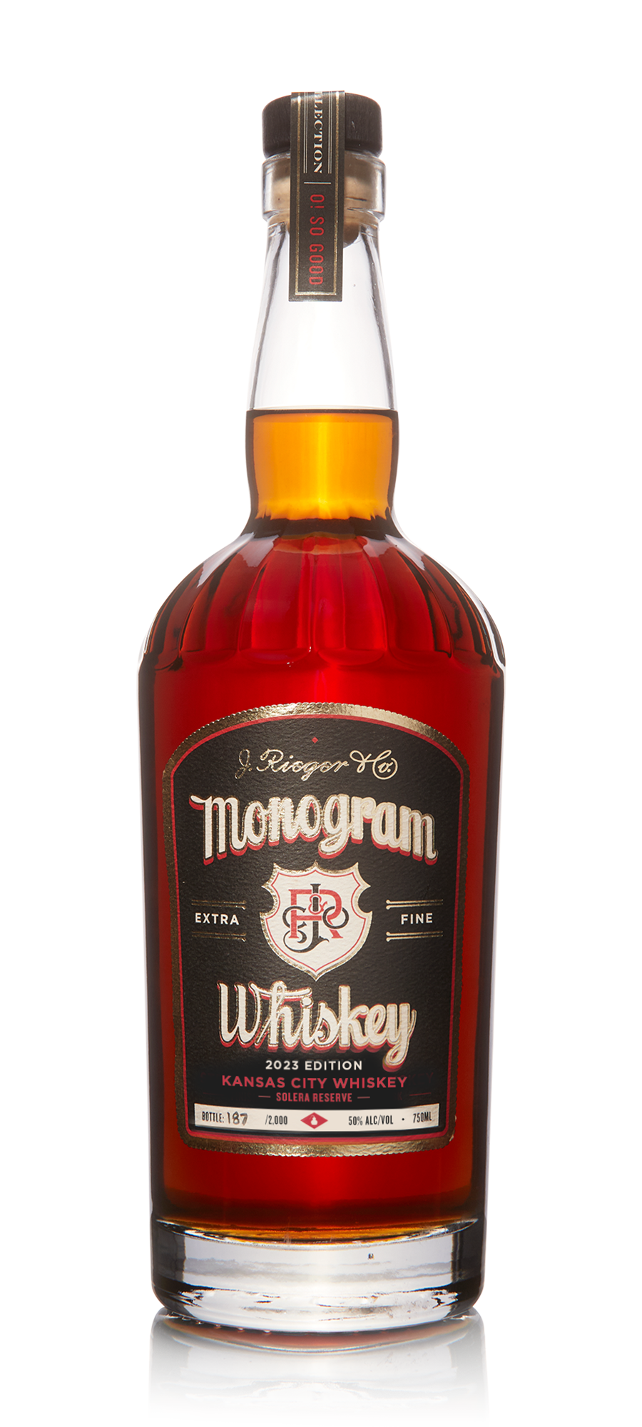 Monogram Whiskey J Rieger & Co 750mL 2023 a tall clear glass bottle with rounded shoulders and a black label and black top